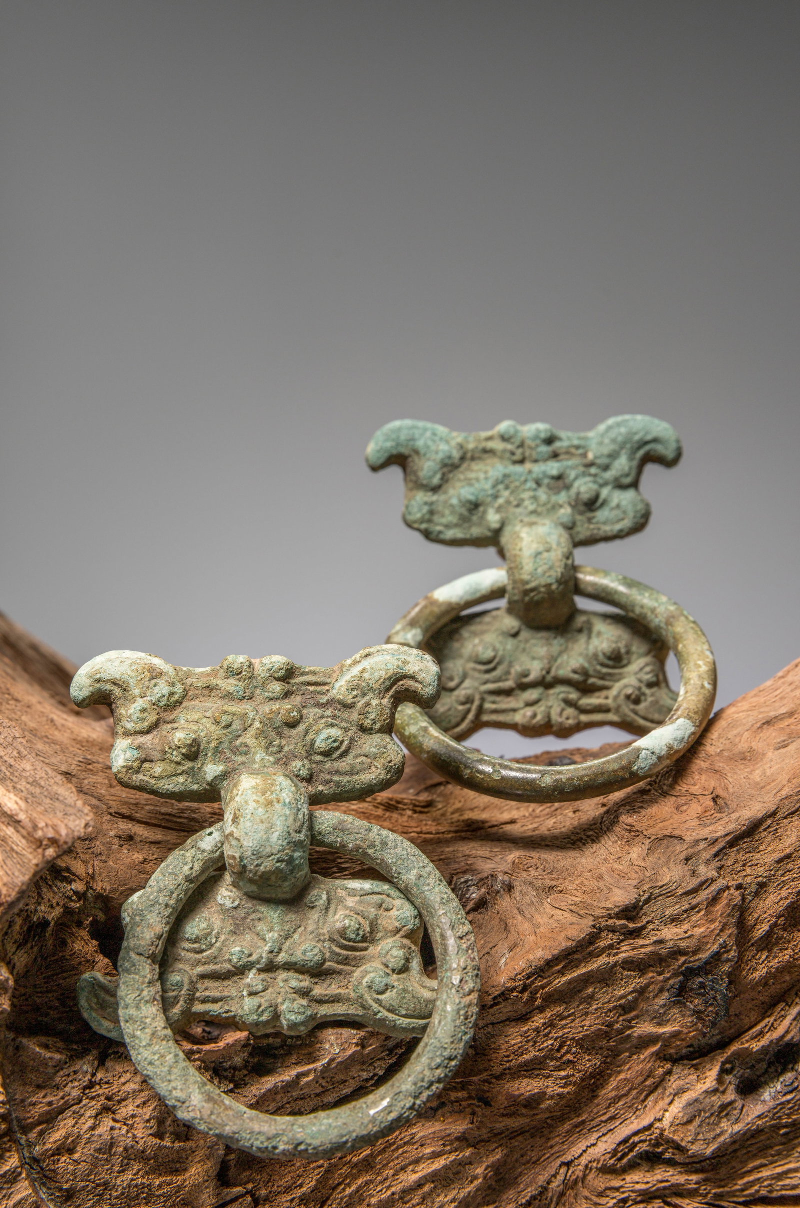 (R) A PAIR OF BRONZE FITTINGS WITH TAOTIE MASKS, CHINA, WARRING STATES PERIOD, 4TH TO 3RD CENTURY BC (1 of 4)