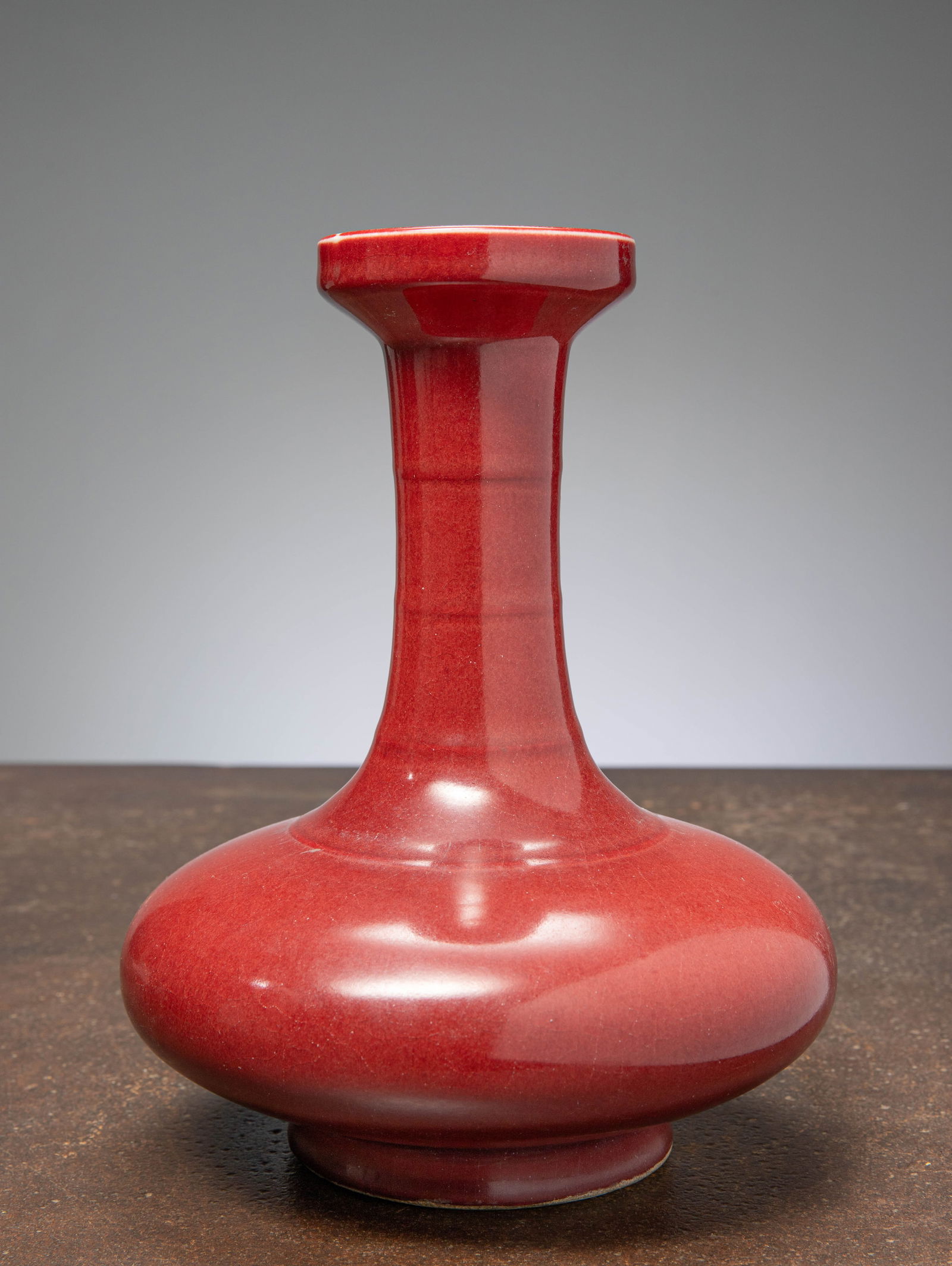 (R) A RARE BULBOUS LONG-NECK VASE, BRICK RED GLAZE, CHINA, QING DYNASTY (1 of 4)