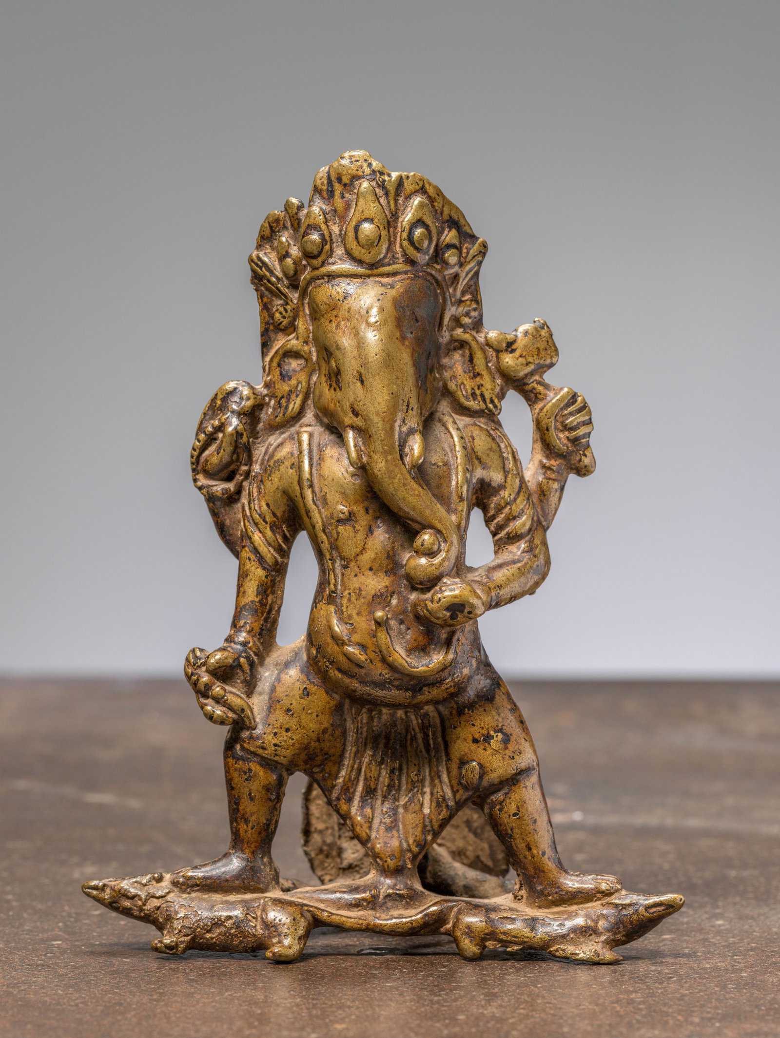 A STANDING BRONZE RESTGILT GANESHA, NEPAL, 17TH CENTURY (1 of 6)