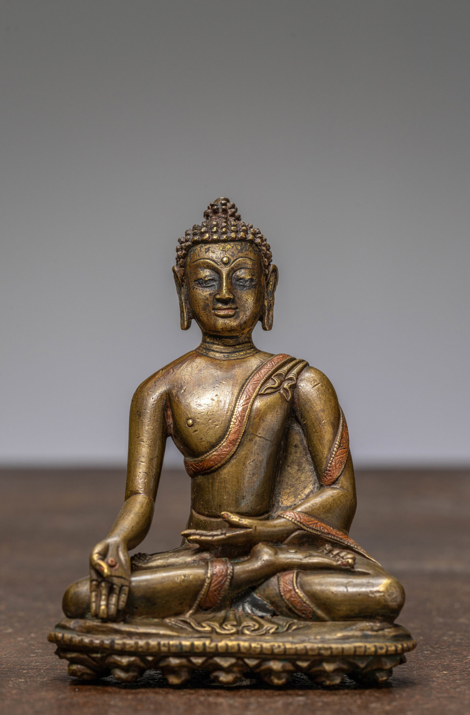 A SEATED BRONZE BUDDHA WITH SILVER AND COPPER INLAYS, TIBET, 13TH CENTURY (1 of 7)