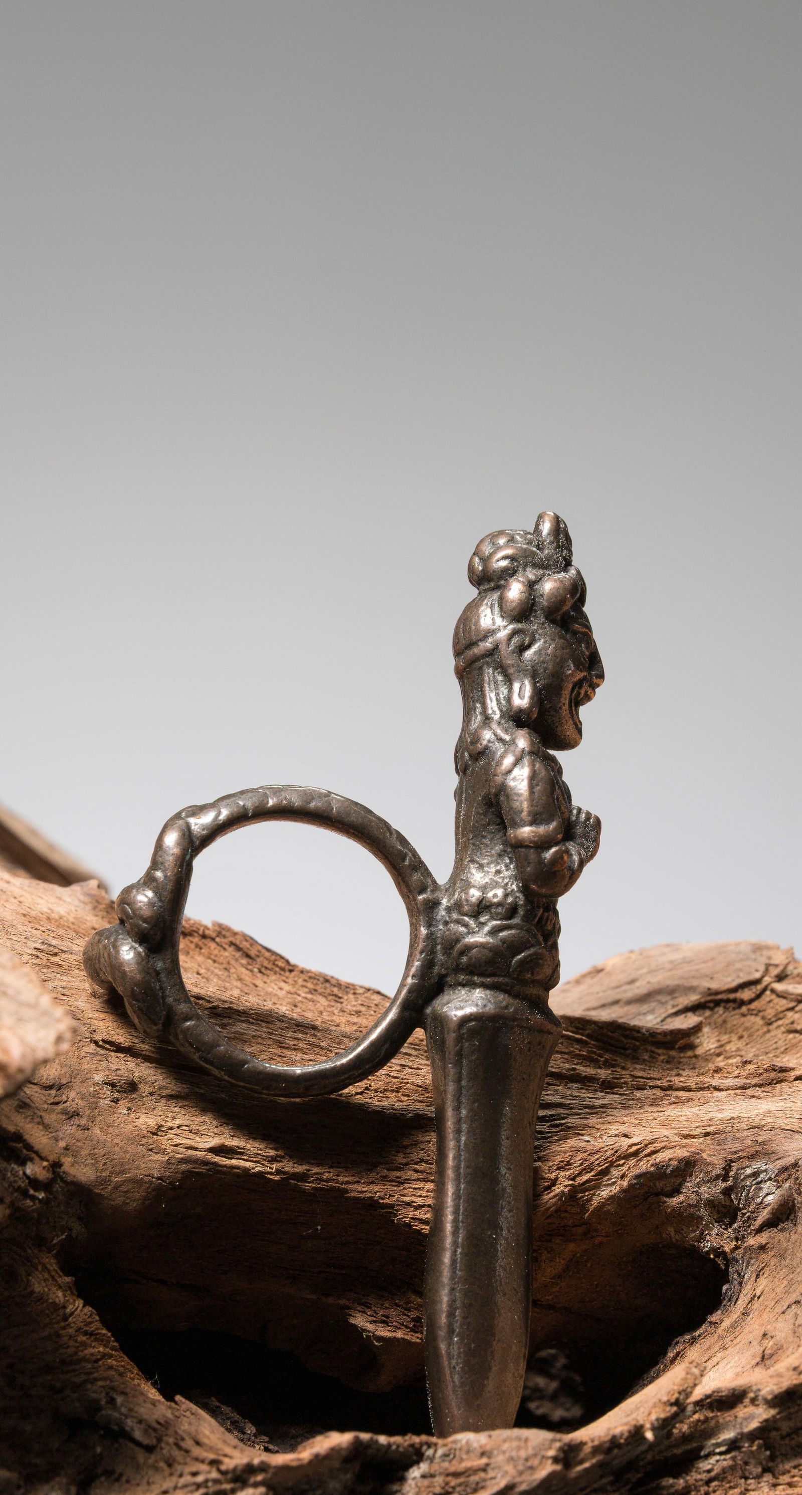 A RITUAL IRON RING CAST AS A WRATHFUL DEITY, TIBET OR NEPAL, 13TH TO 15TH CENTURY (1 of 5)