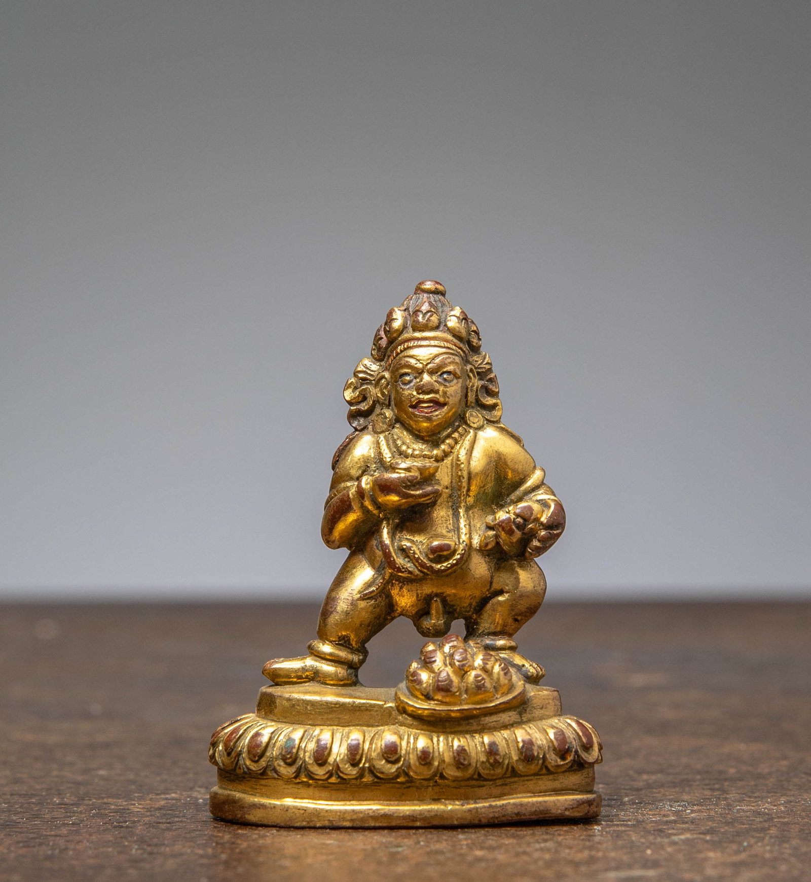 A GILT-BRONZE FIGURE OF JAMBHALA, TIBET, 18TH CENTURY (1 of 6)