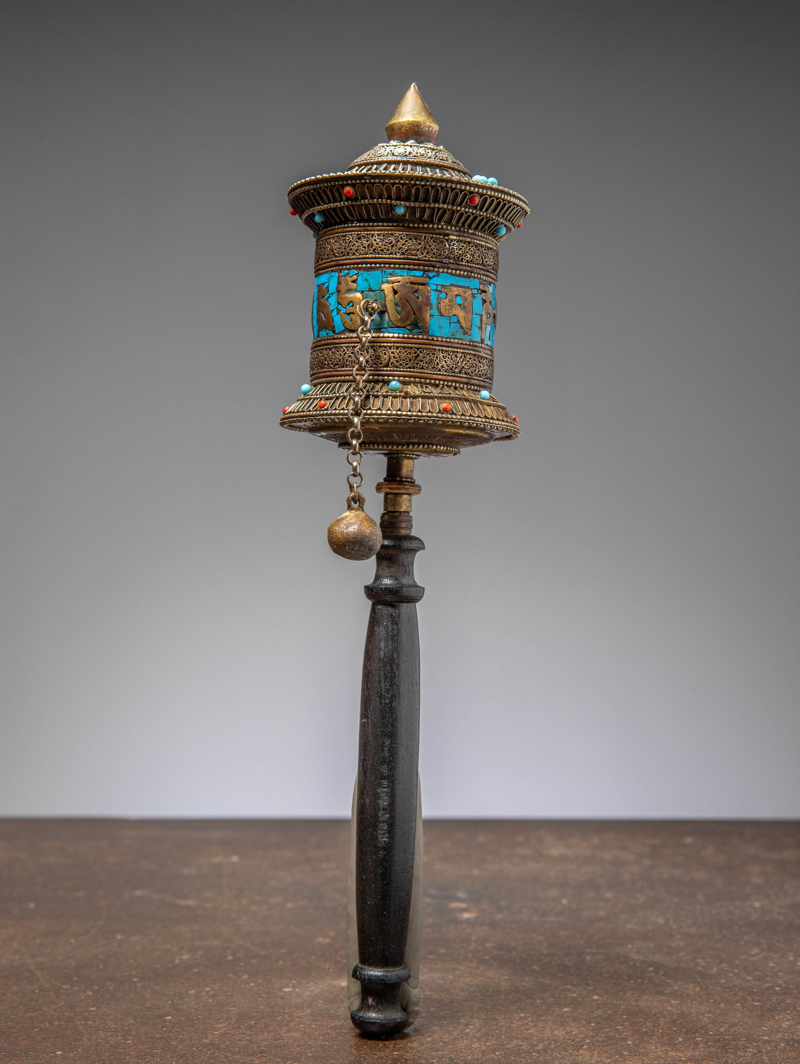 (R) A TIBETAN HANDHELD PRAYER WHEEL, METAL AND TURQUOISE INLAY, CIRCA 1950 (1 of 1)