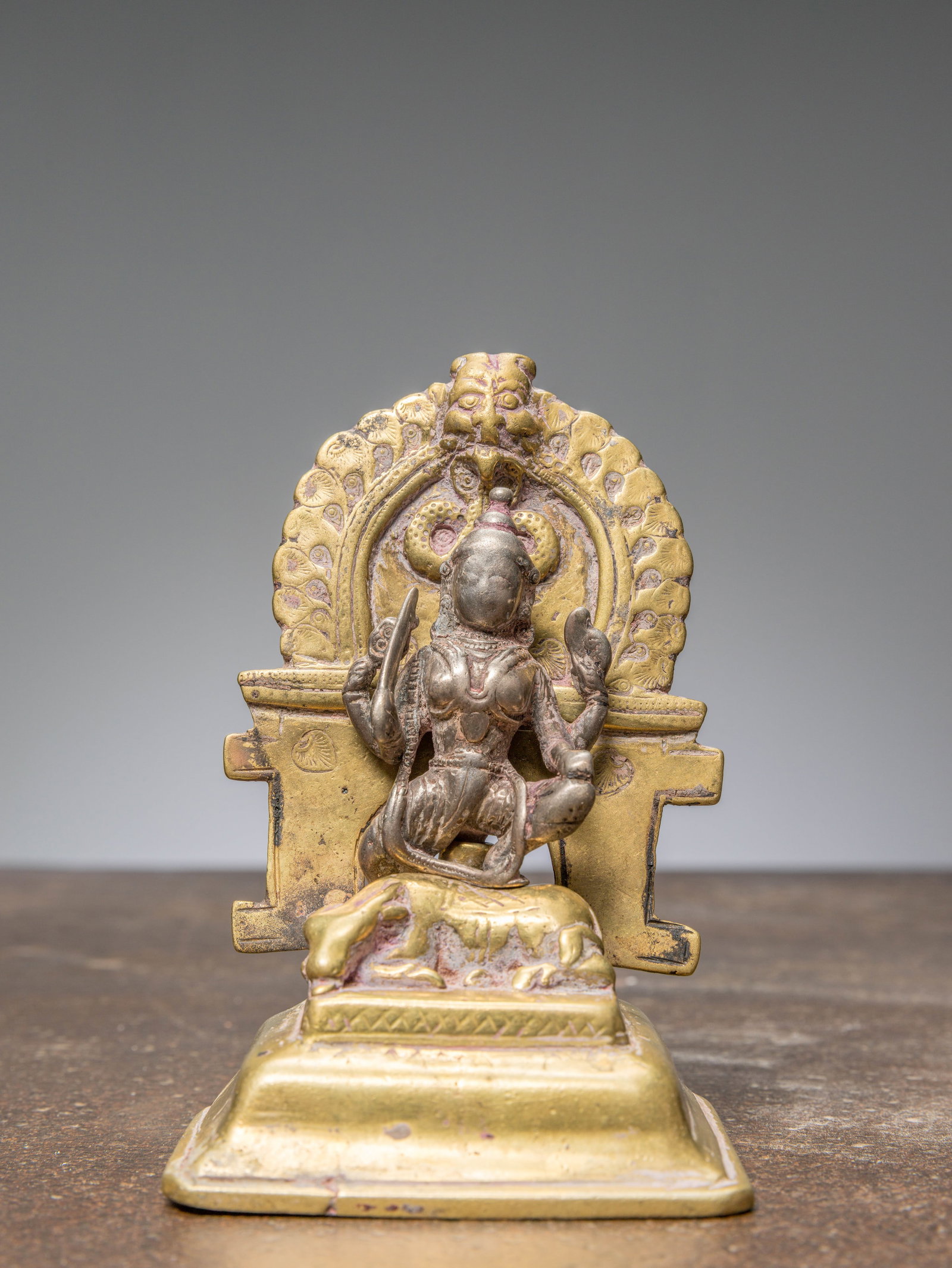 A SILVER DURGA ON BRASS SHRINE, INDIA, 17TH CENTURY (1 of 6)