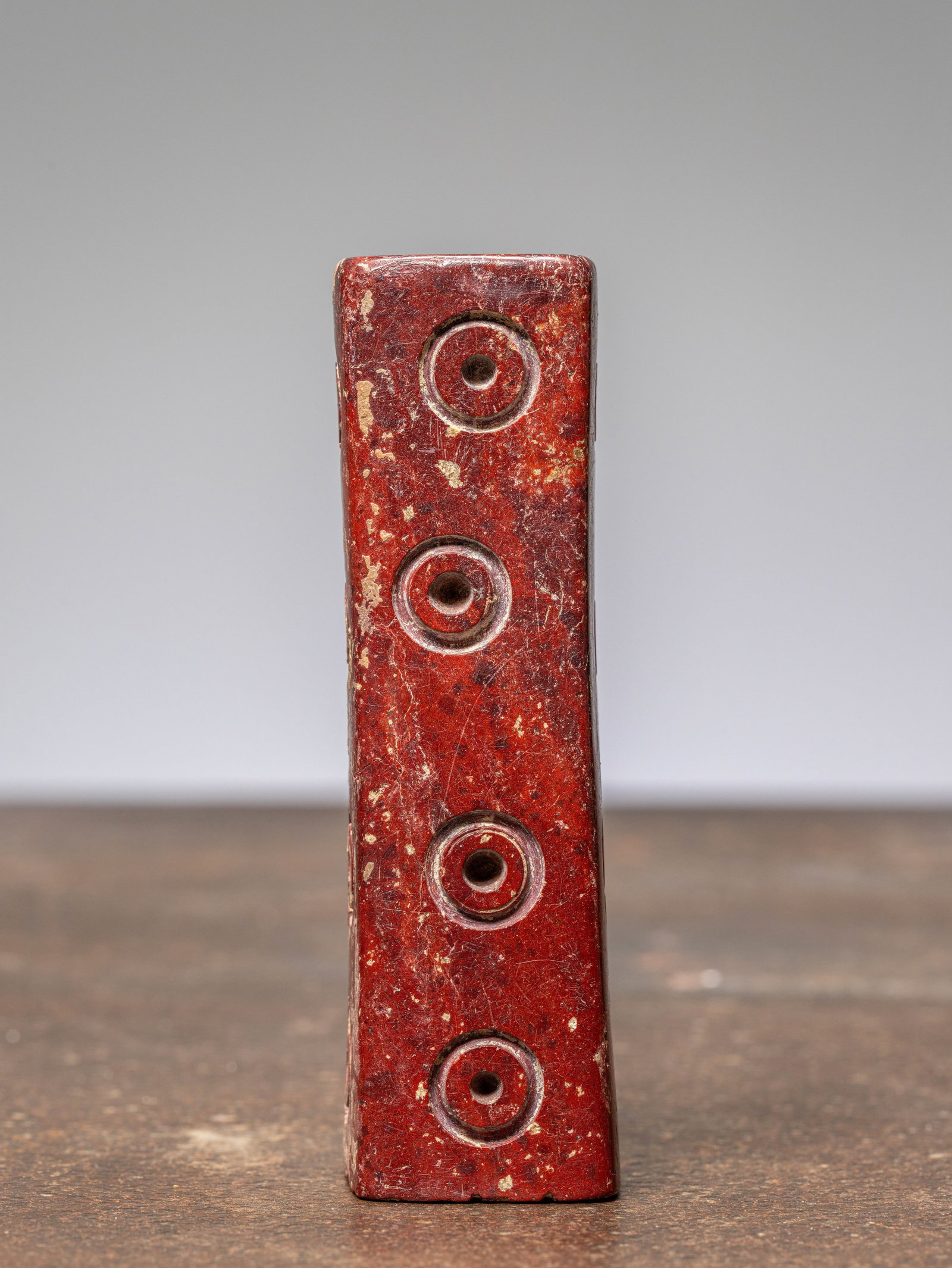 AN EARLY INDIAN OR BAKTRIAN DICE, 1500 BC, MADE OF STONE: Dimensions: Height 13 cm Wide 3,5 cm Depth 3,5 cm Weight: 434 grams Rectangular stone die with four drilled circular pips arranged longitudinally on each face, the ends pierced with a single a