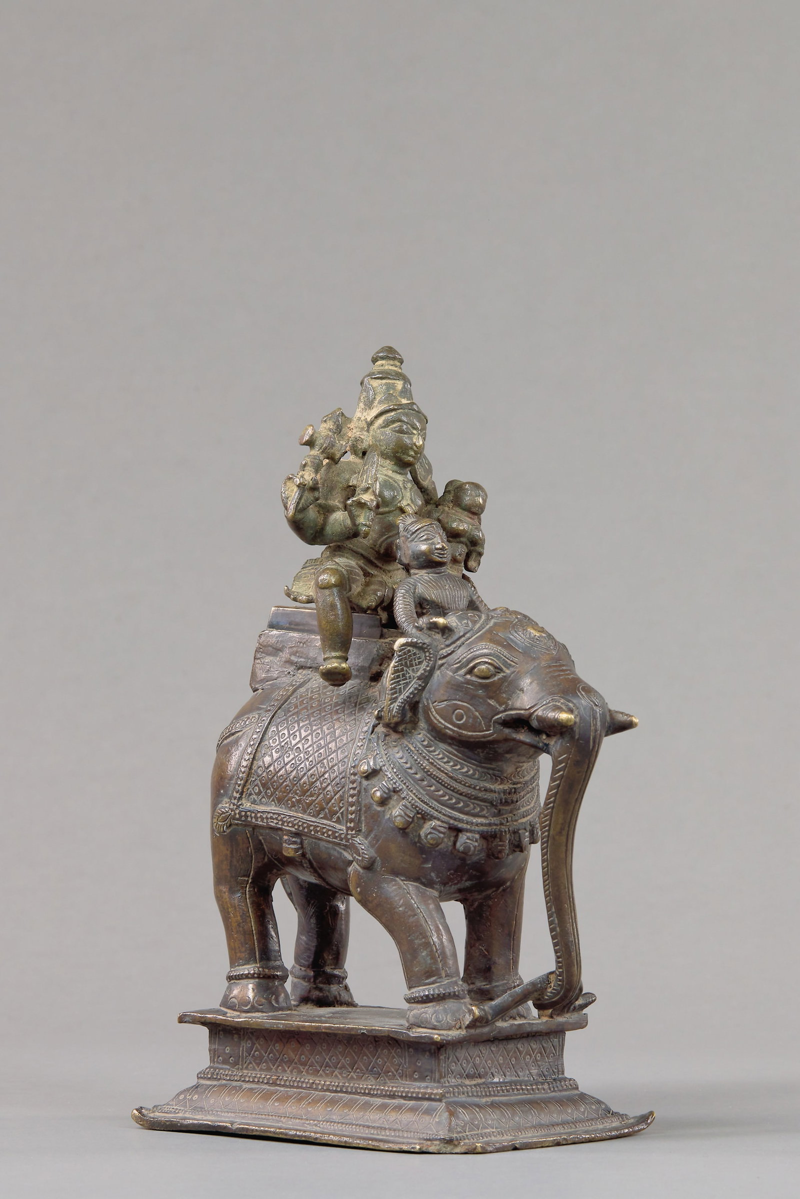 SHIVA AND PARVATI ON ELEPHANT BRONZE INDIA 18TH CENTURY: Dimensions: Height 17,6 cm Wide 7,5 cm Depth 12 cm Weight: 1336 grams Cast in bronze, the divine couple Shiva and Parvati are depicted seated upon a richly caparisoned elephant standing atop a