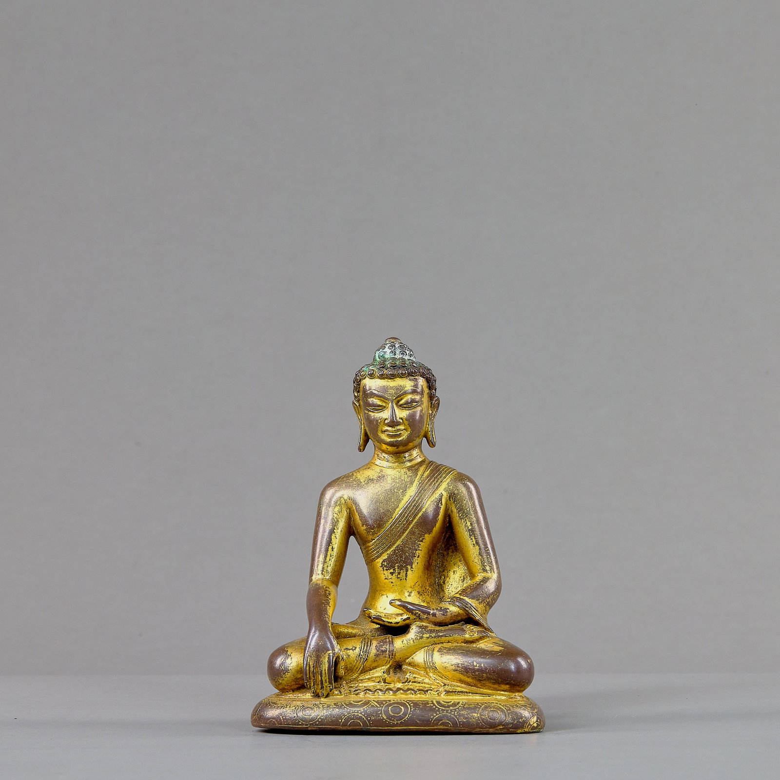 A SEATED BRONZE GILT BUDDHA, TIBET, 15TH CENTURY (1 of 8)