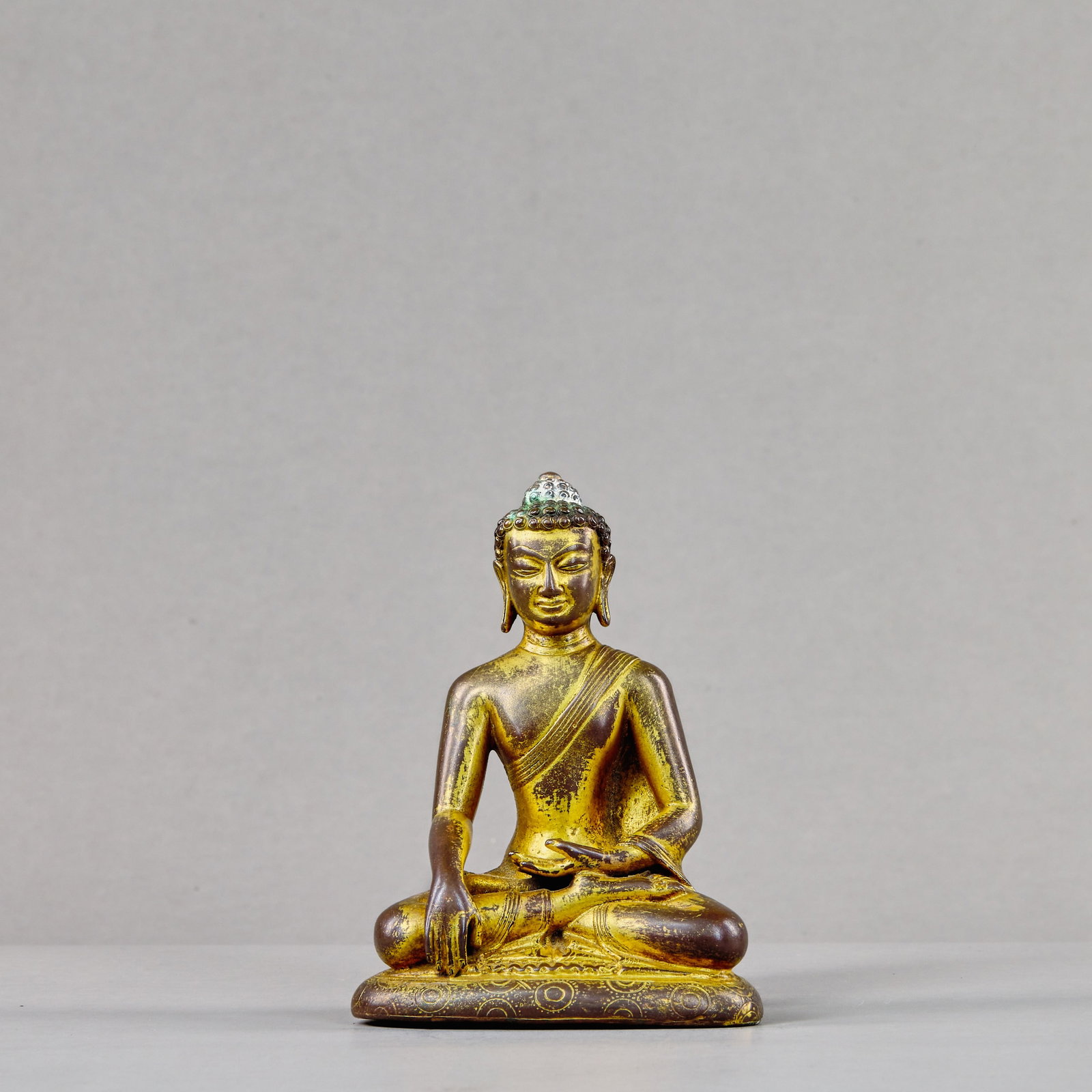 A SEATED BRONZE GILT BUDDHA, TIBET, 15TH CENTURY (1 of 8)