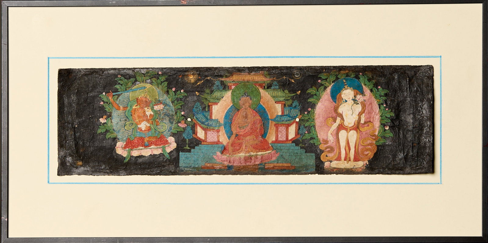 ILLUMINATED MANUSCRIPT DEPICTING MANJUSHRI, BUDDHA AND WHITE TARATIBET, 17TH CENTURY: Dimensions: Height 11 cm Wide 38 cm Weight: 756 grams Pigments and gold on paper. A rare painted manuscript book cover depicting a central Buddha seated i