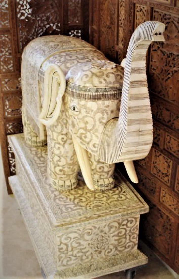 43x36" Antique Chinese Elephant Statue: Mosaic Bone Art: Antique Chinese Elephant Statue on Matching Mount Made of Camel Bone and Carved with Images of Flowers and Dragons in a mosaic artform. The detail is mesmerizing! Approx. 200-300 lbs. 43"Long x 36"Hig