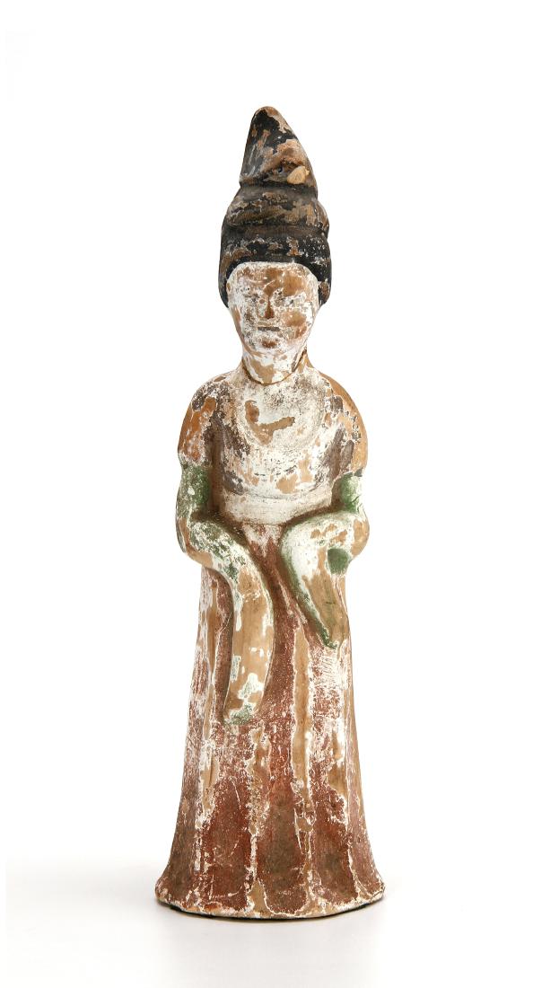 Painted Pottery Figure of Lady: Well modeled, standing in an elegant swaying pose with hands clasped within the full sleeves of the long, heavy robes falling in deep folds to the base, with a shawl over the shoulder and long robe cu
