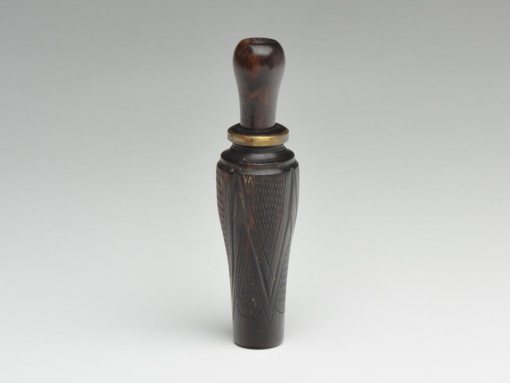 Checkered duck call, A.M. Bowles, Little Rock,: Checkered duck call, A.M. Bowles, Little Rock, Arkansas. Appears to be ebony wood. Fine checkering on all four panels. Stamped by maker at top of barrel. 6.5". Provenance: Brian Stead collection.