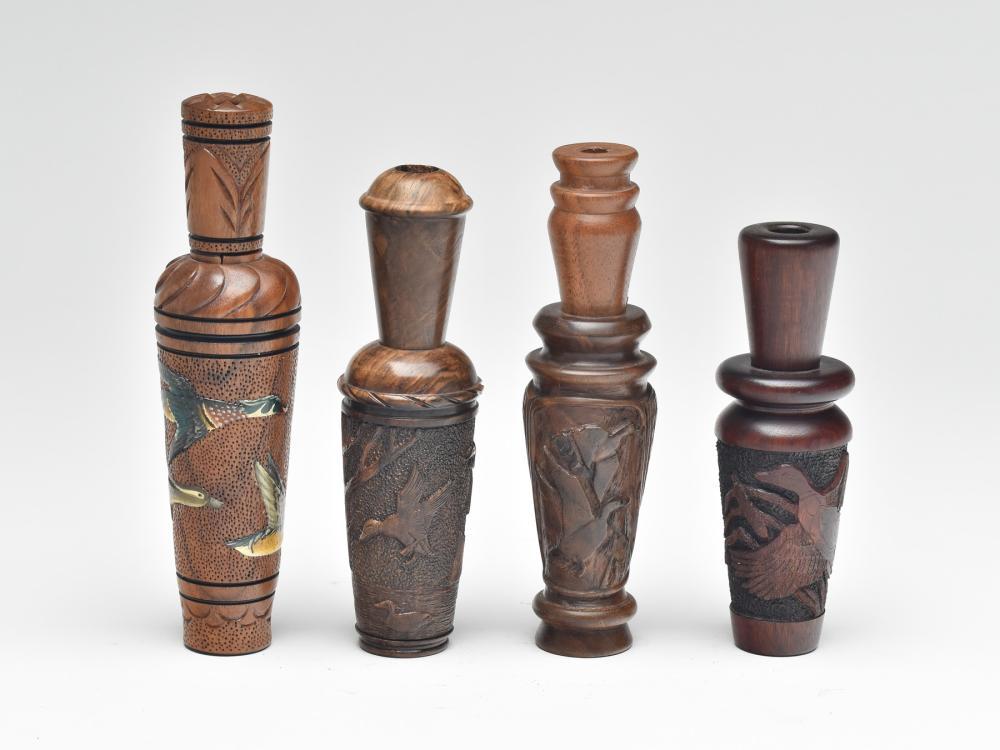 Four heavily carved duck calls by different makers.: Four heavily carved duck calls by different makers. Call with wood ducks on barrel by Virgil Hodges, excellent and original. Call that is checkered by Gerald Crawford excellent and original. Walnut ca