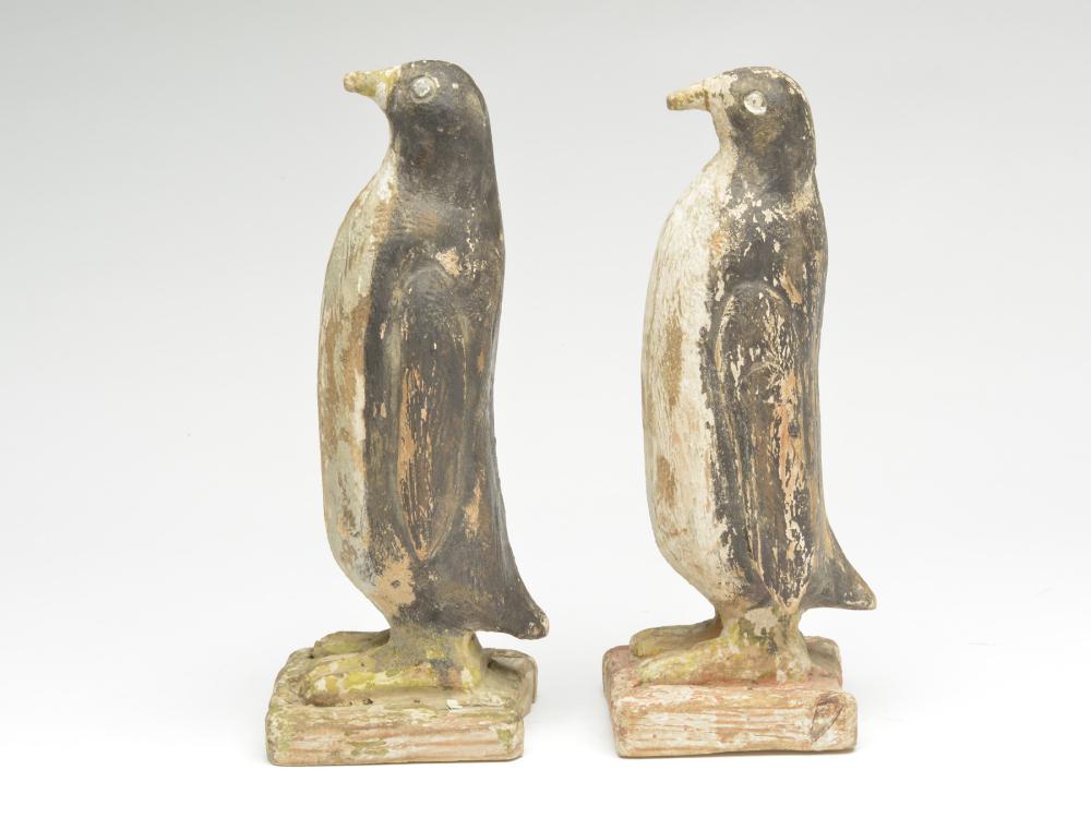 A pair of penguins.: A pair of penguins. Each is carved from a laminate piece of wood. Both have carved eyes, carved wings, and feet. 12" tall. Provenance: Steven Michaan collection.
