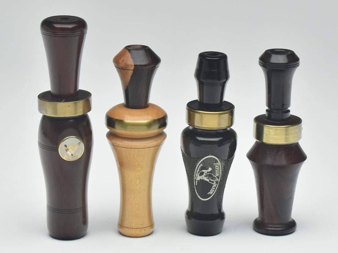 Four duck calls, by various makers.: Four duck calls, by various makers. Two by Alvin Taylor one with label on barrel, one by Buddy Duke, and one by Bill Grant which is signed and numbered 1610 on brass ring at collar and has an inset me