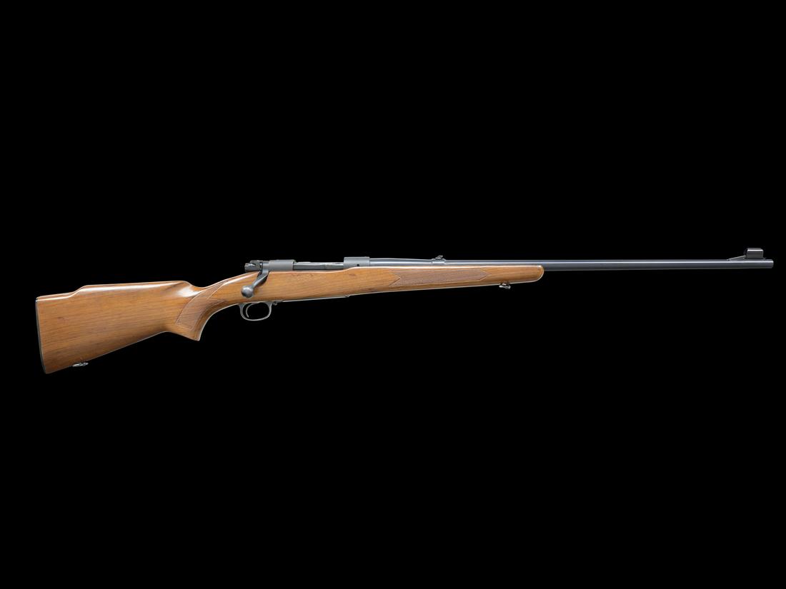 SCARCE WINCHESTER PRE-64 MODEL 70 WESTERNER BOLT ACTION RIFLE: SN: 539159. Cal. 264 Win Mag. 26" blue steel bbl. Hooded front sight, flip-up rear sight. 3-position safety. Walnut monte carlo stock w/ steel floorplate and plastic buttplate. MFG 1961.