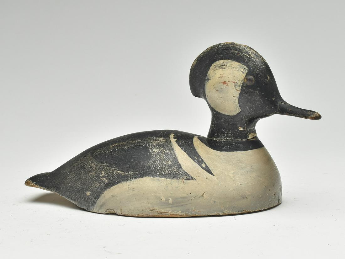 Excellent little hooded merganser from eastern Ontario, circa 1930.: Slightly turned head with extended carved crest and tack eyes. Comb feather paint detail on back. Two inlayed round lead weights on the underside. Delicate thin bill carving that has never sustai