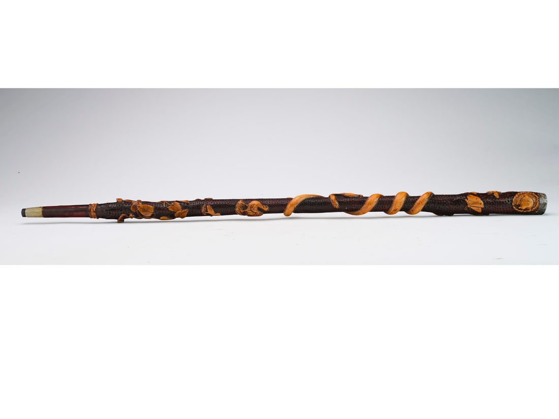 J.P. Kohlbach: Folk art carved walking stick, dated 1901. Reads "By J.P. Kohlbach" in a banner on the lower side. Covered in a honey comb pattern with decorative objects carved from top to bottom including: hor