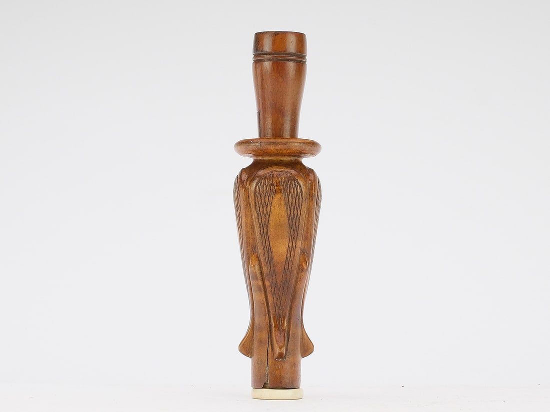 Gerald "GD Devereaux Kinney, Memphis, Tennessee.: Exceptional duck call and rare example from this important maker. Four raised panels with an exaggerated collar at top of barrel. Copper reed. A bone mouth piece with "WSK 21" carved in one side made