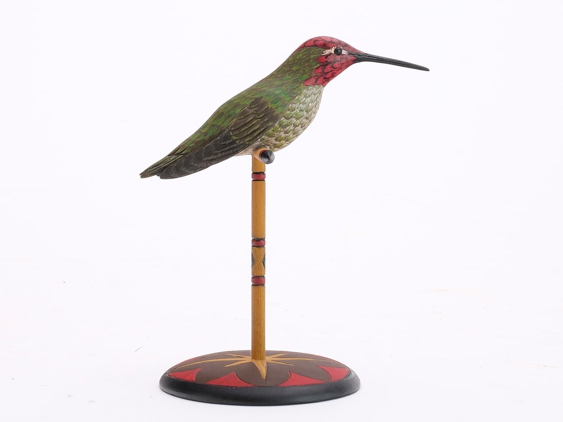 Eddie Wozny (b.1959), Cambridge, Maryland.: Full size hummingbird perched on decorative base. Signed on underside, and dated 2010. Species is a annas hummingbird. Wingtips are dropped and slightly separated from body. Carved feathers. Stan