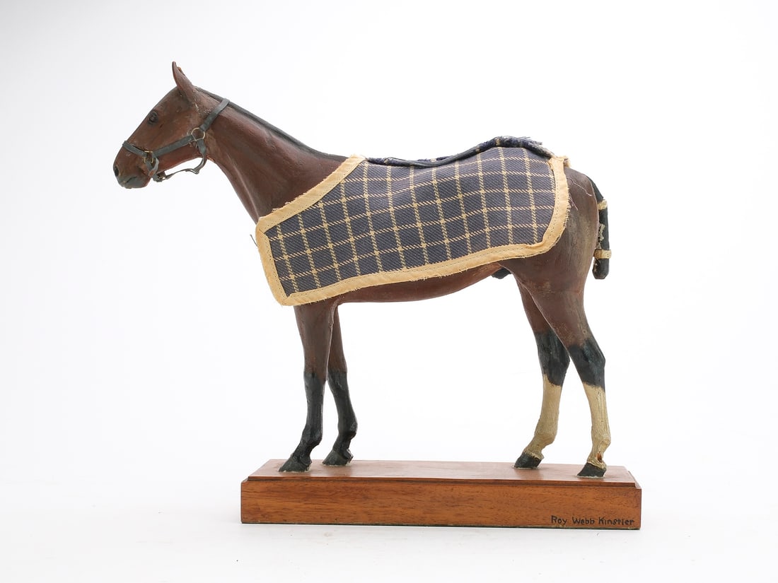 Carved and painted horse with tied tail, mane, and harness around head. (1 of 4)