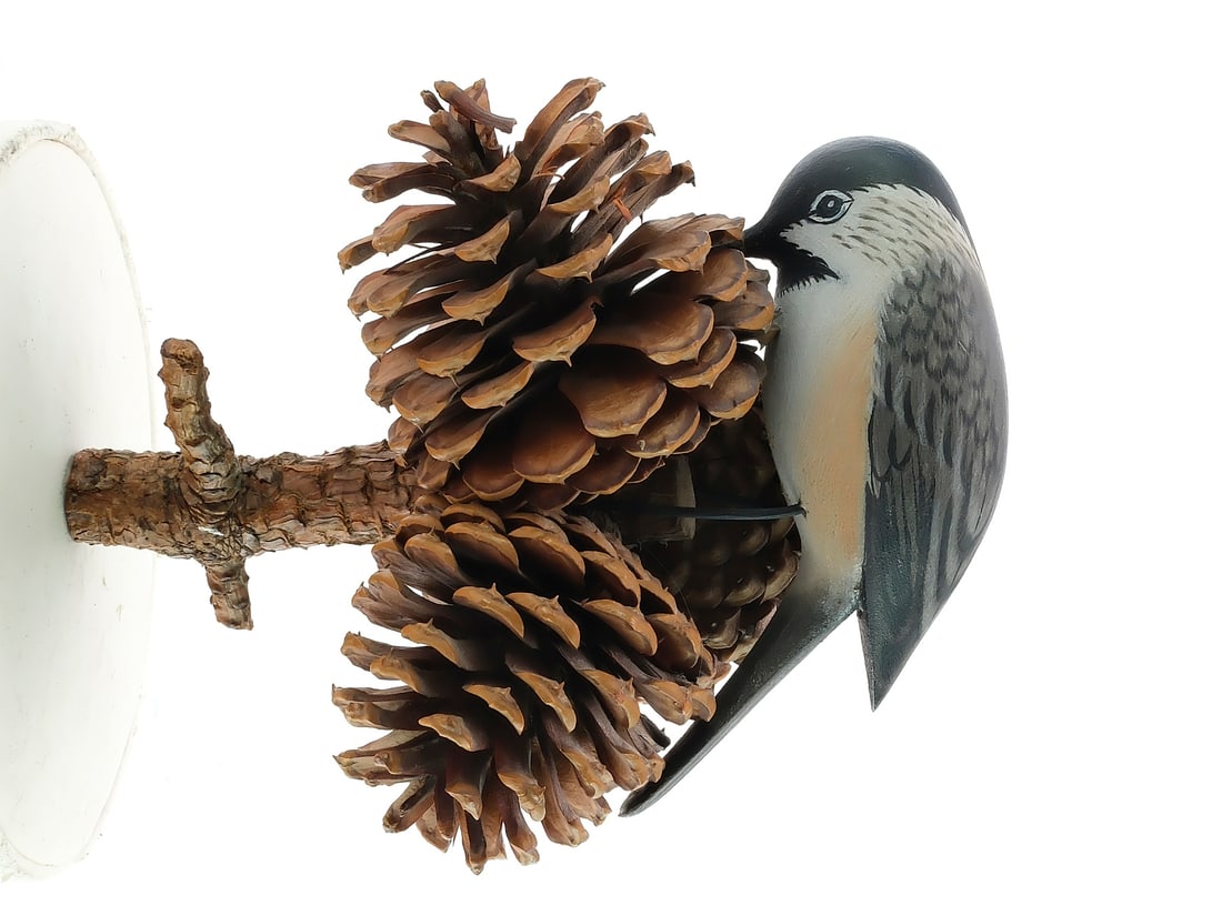 A. Elmer Crowell (1862-1951), East Harwich, Massachusetts.: Full size chickadee on pine branch with three pine cones. Made to screw into a wall. Chickadee measures 4" long.