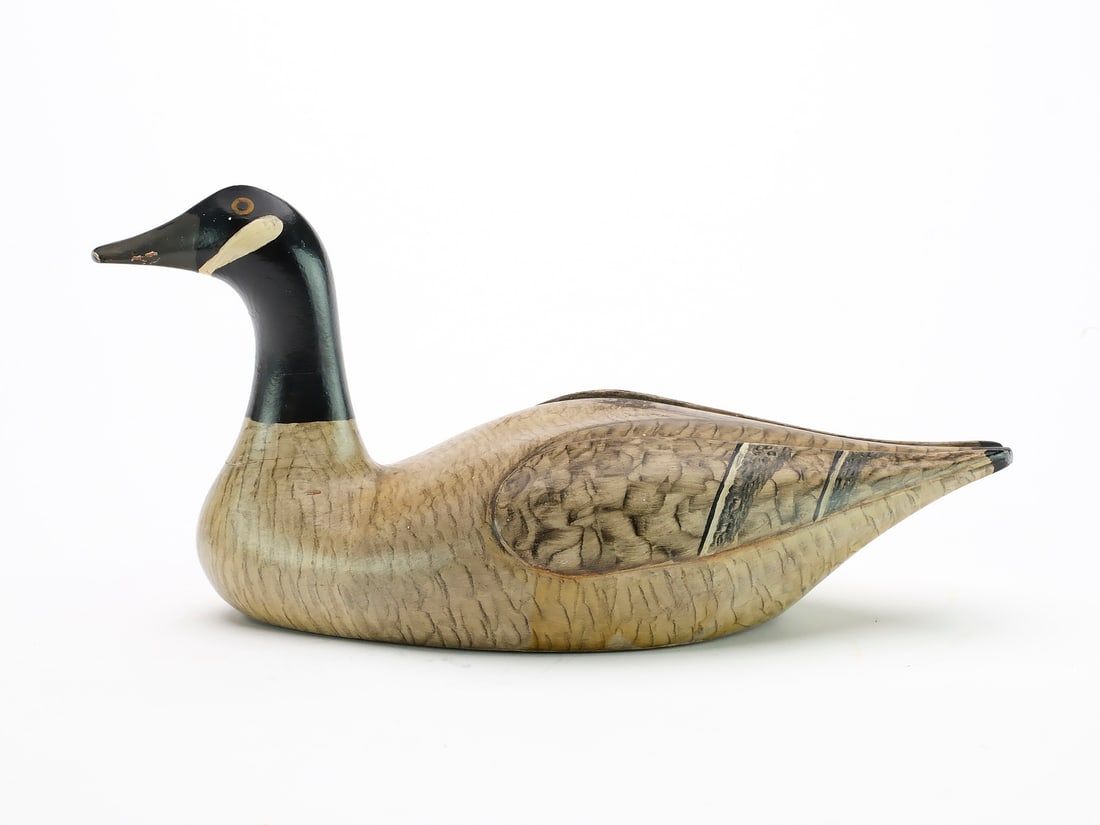 Frank Adams (1871-1944), West Tisbury, Massachusetts.: 10" long Canada goose paper weight with deep relief wing carving and original paper label on underside.