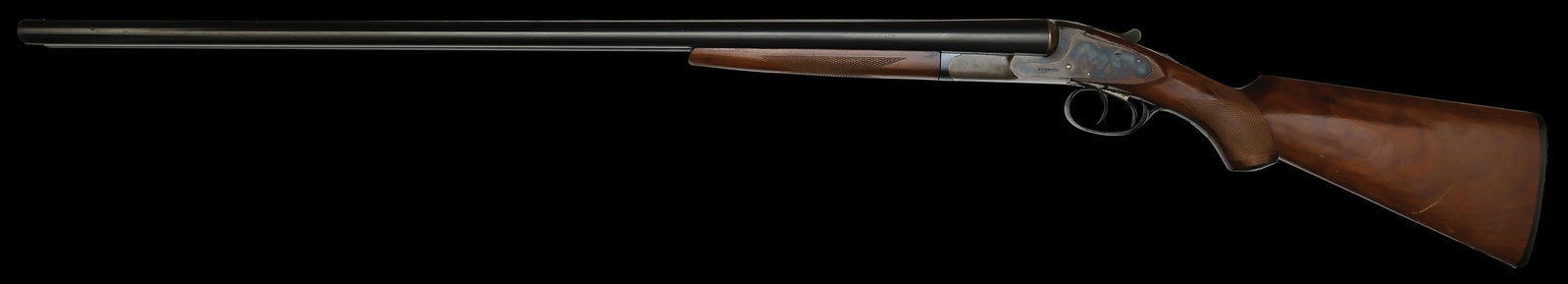 HIGH CONDITION L.C. SMITH FIELD GRADE 12 GAUGE SHOTGUN.: SN. R107157. Cal. 12ga. Built with 32" Armor steel brls that have matted concave top rib with small brass front bead. Brls with usual maker's stamps. Walnut splinter forend checkered in point pattern 