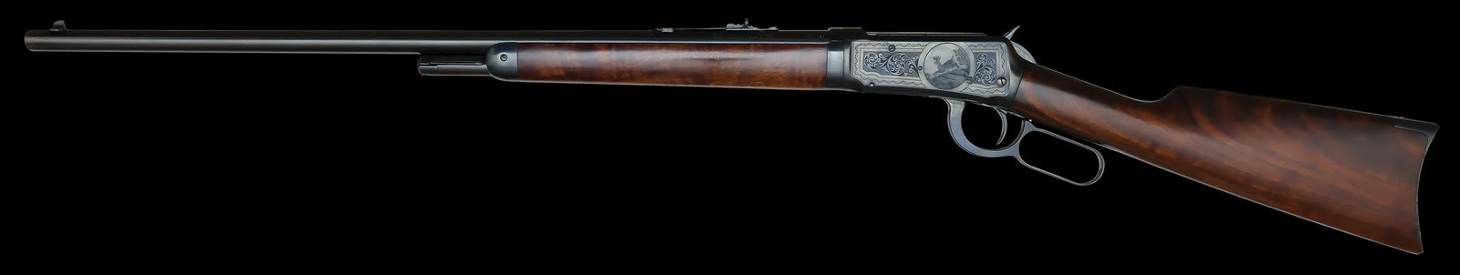 EXCELLENT WINCHESTER MODEL 1894 ENGRAVED RIFLE.: SN. 633110. Cal. .32 WS. Built with 26" blued round brl that has usual maker's stamps with adjustable rear sight and blade front sight. Button magazine. Blued forend cap and walnut forend. Blued recei