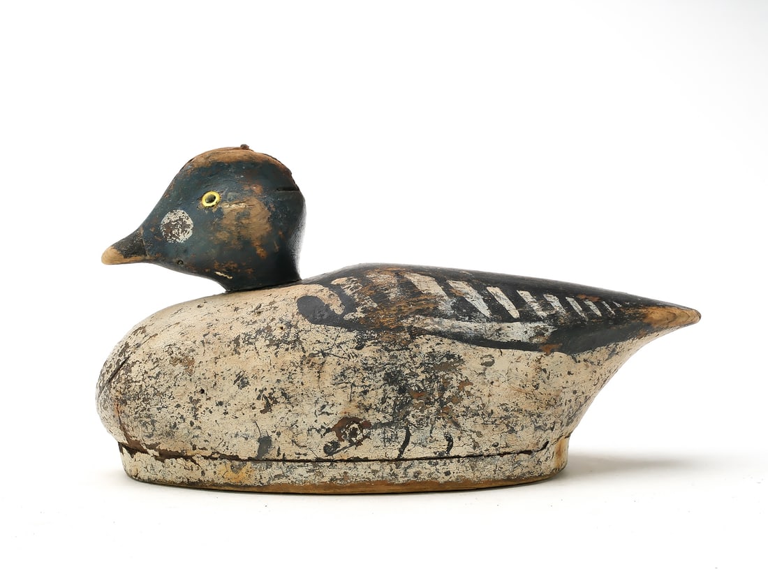 Unknown maker, Cape Cod, Massachusetts.: Hollow carved goldeneye drake with bulbous, slightly turned head. “S” branded on the underside for the rig of Stanley Smith. Measures 12” long. Provenance: Ted and Judy Harmon collec