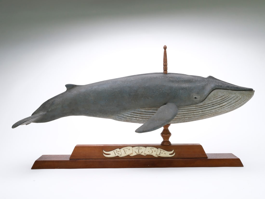 Frank Finney (b.1947), Cape Charles, Virginia.: Hollow carved blue whale weathervane. Custom stand with inlayed bone bannerette of maker’s full initials “RFSF”, for Royland Frank Smith Finney. Measures 30" long.