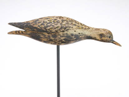 A. Elmer Crowell (1862-1951), East Harwich, Massachusetts.: Rare golden plover in running pose with relief wing feather carving. Two stick holes drilled in underside. Measures 12&#8221; long. Provenance: Ted and Judy Harmon collection.&#160; Literature: &#8220