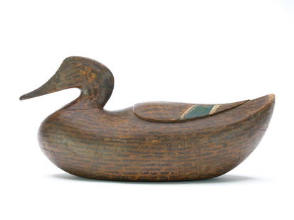Caines Brothers, Georgetown, South Carolina, late 19th century.: Very appealing mallard hen with deep relief heart pattern wing carving. Reared back head and upswept tail. Made for use at Hobcaw Barony, near Georgetown, South Carolina. Measures 16.25&#8221; long.&#