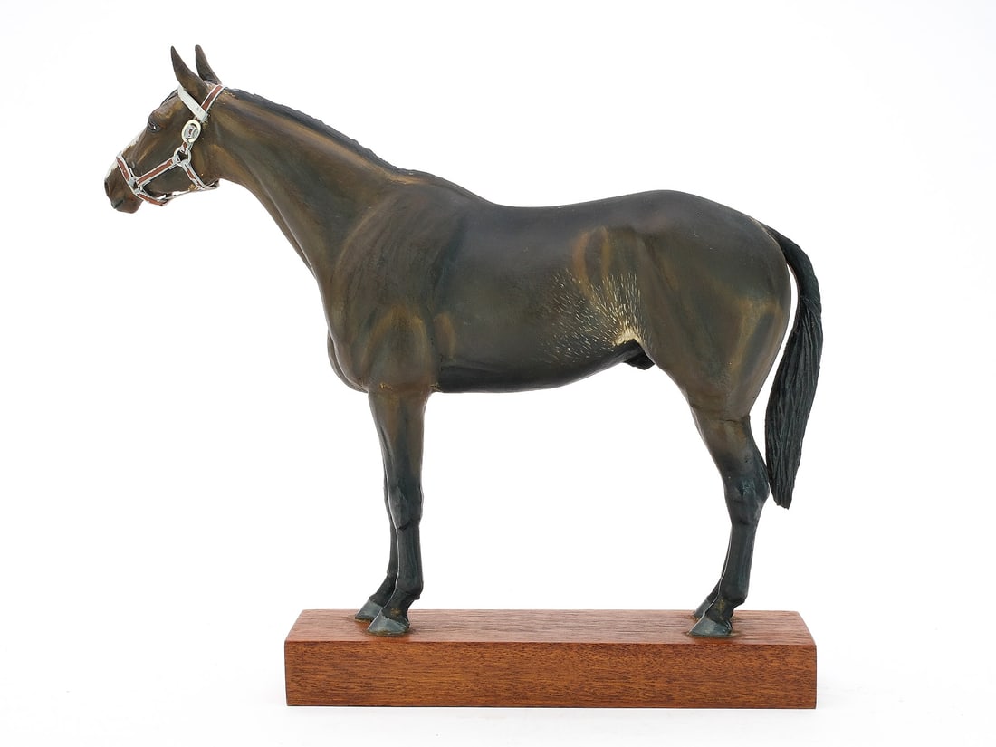 Calvin Kinstler (1890-1954): Carved model of a hunter horse. Relief carved mane and applied wooden ears and tail. Painted metal bridle. Signed by the maker on one side of base. Measures 12" long, 10.5" tall.