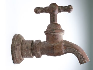 Early plumbing trade sign in the form of a faucet.