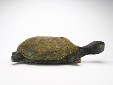 Early 20th century pull toy in the shape of a turtle.