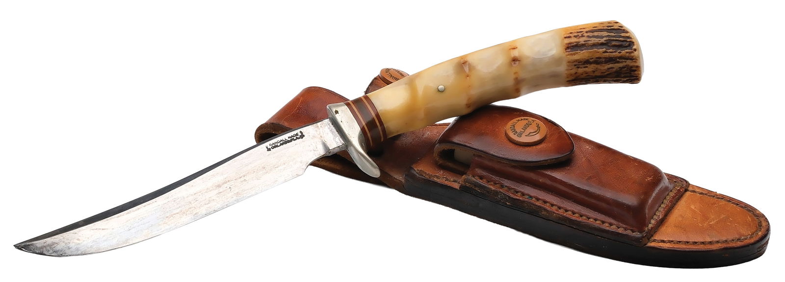 RANDALL MADE KNIVES MODEL NO. 4 WITH SHEATH.: 5" blade. Left side stamped "RANDALL MADE/ORLANDO FLA.". Stag handle with finger grooves. Housed in a H.H. Heiser single stitch sheath with light brown sharpening stone. Very good original. 6454.