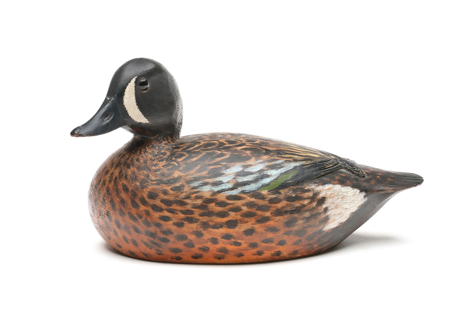 A. Elmer Crowell (1862-1952), East Harwich, Massachusetts.: Outstanding bluewing teal. Relief carved and crossed wingtips. Relief tail feather carving. Head is turned 45 degrees. Maker's oval brand in underside. Made for Dr. John C. Phillips. Measures 11" long