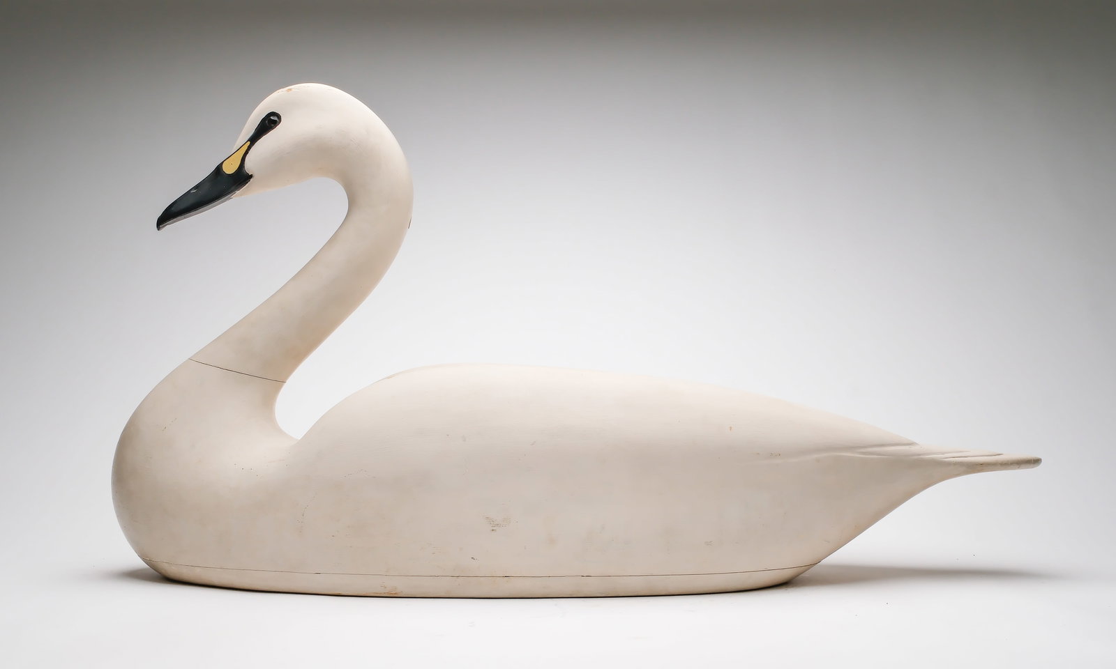 Charles E. "Shang" Wheeler (1872-1949), Stratford, Connecticut.: Exceedingly rare swan. Hollow carved with relief wing carving and reared back head. Swan was rigged and weighted, with a wooden keel that has since been removed. Measures 37.5" long. Provenance: Estat