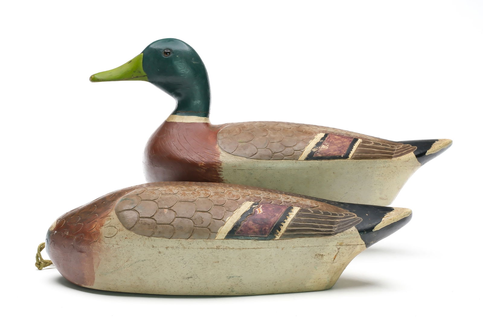 Alfred Moes (1896-1960), Lakeville, Minnesota.: Two mallard drakes. One is a feeder, the other is in a upright pose. Both have round lead line tie weights that fit into a cutout on the underside of the body and detailed feather carving. Measure