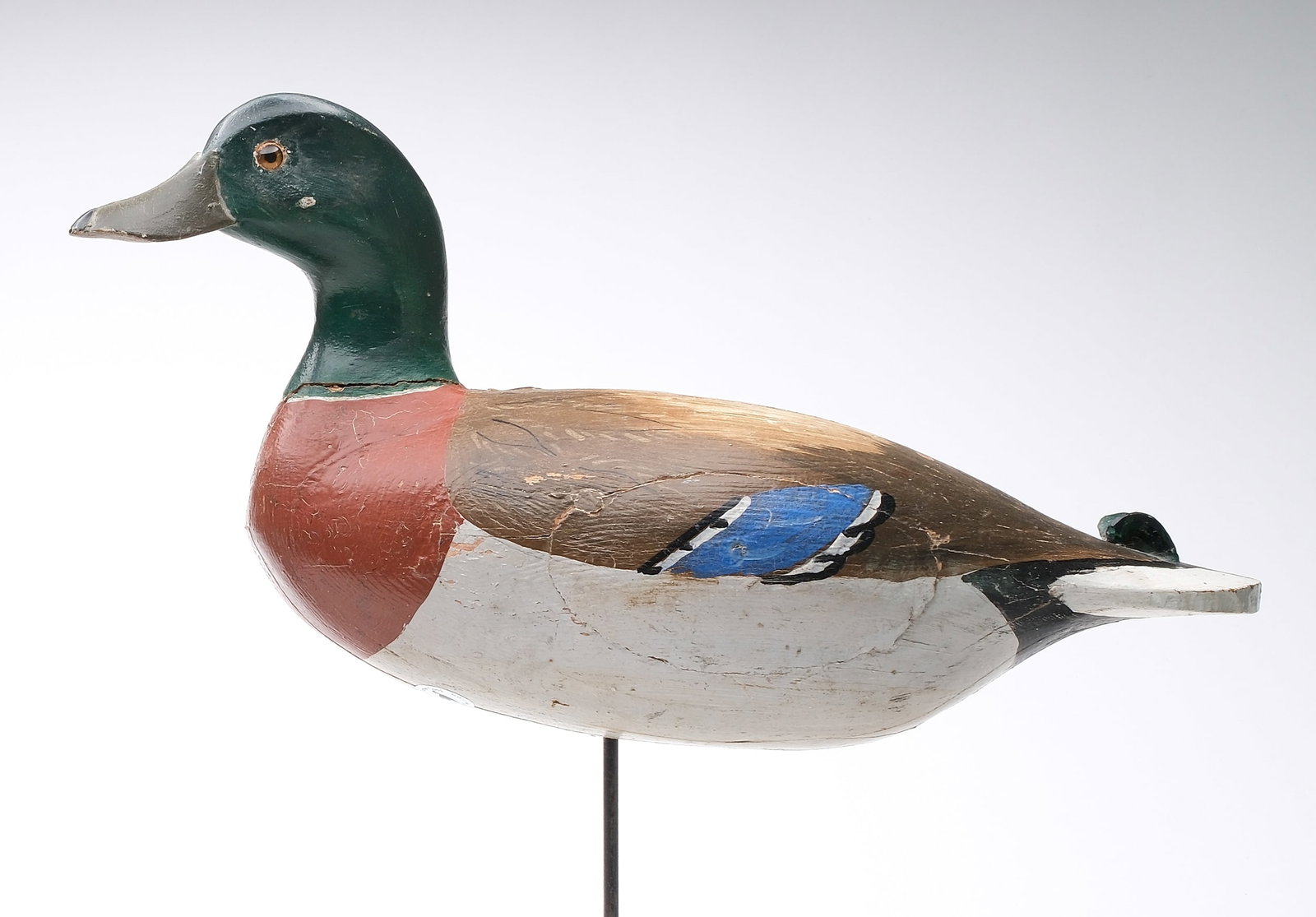 John Tax (1894-1967), Osakis, Minnesota.: . Rare stick up mallard. Hollow carved vertical laminate construction with slightly turned head and applied wooden tail sprig. Two separate holes drilled in underside for positioning. One appears to b