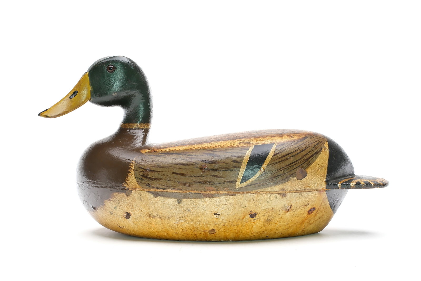 John Scholer (1861-1949), Burlington, Iowa.: Oversized mallard. Hollow caved with slightly turned head. Scratch feather paint detail on back. Measures 17.5" long. Provenance: Jim and Diane Cook collection.