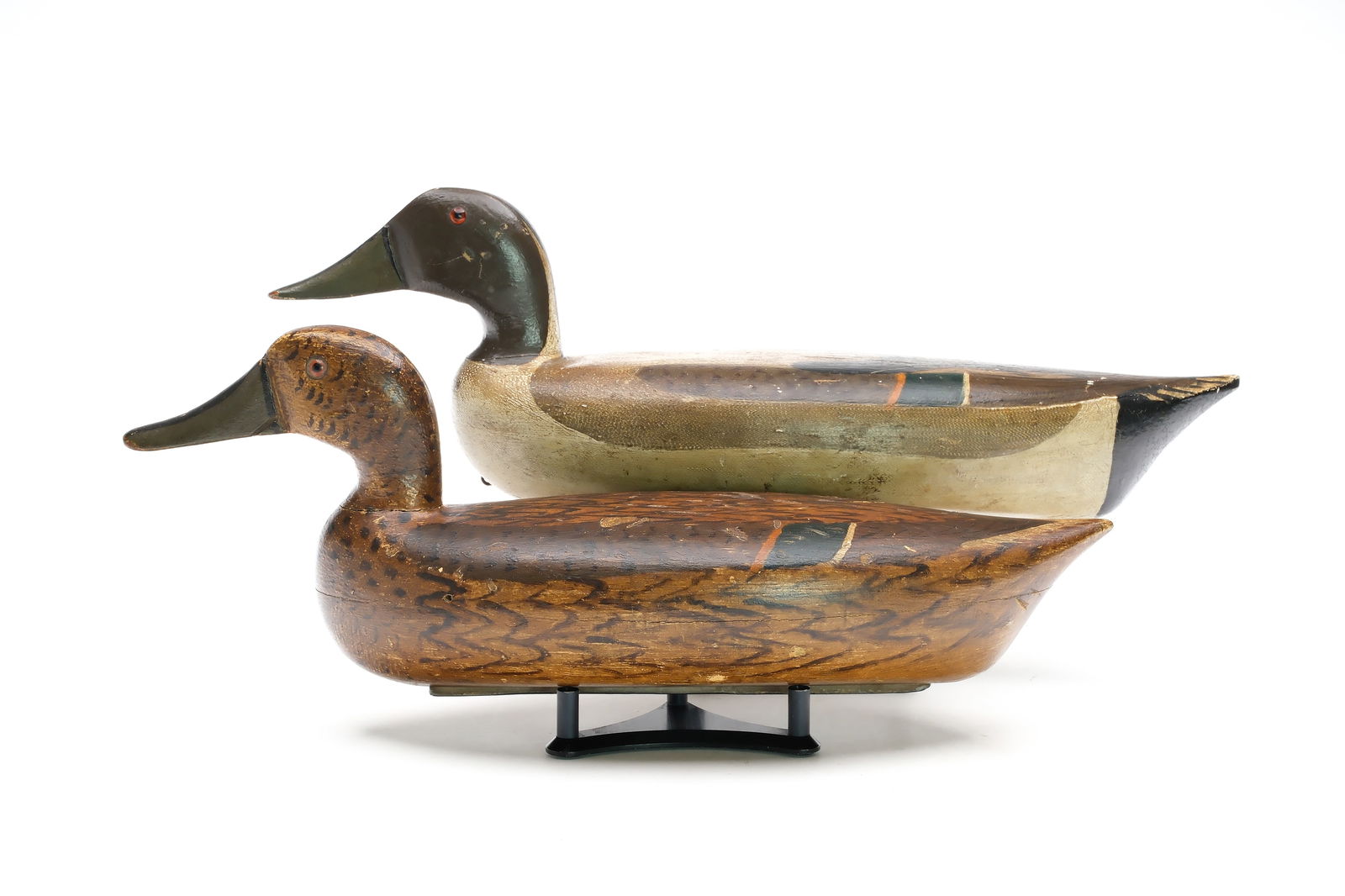 William Lohrmann (1890-1955), Peoria, Illinois.: Rigmate pair of pintails. Hollow carved with long bodies. Fine comb feather paint detail on drake. Measure 17" and 19" long. Provenance: Jim and Diane Cook collection.