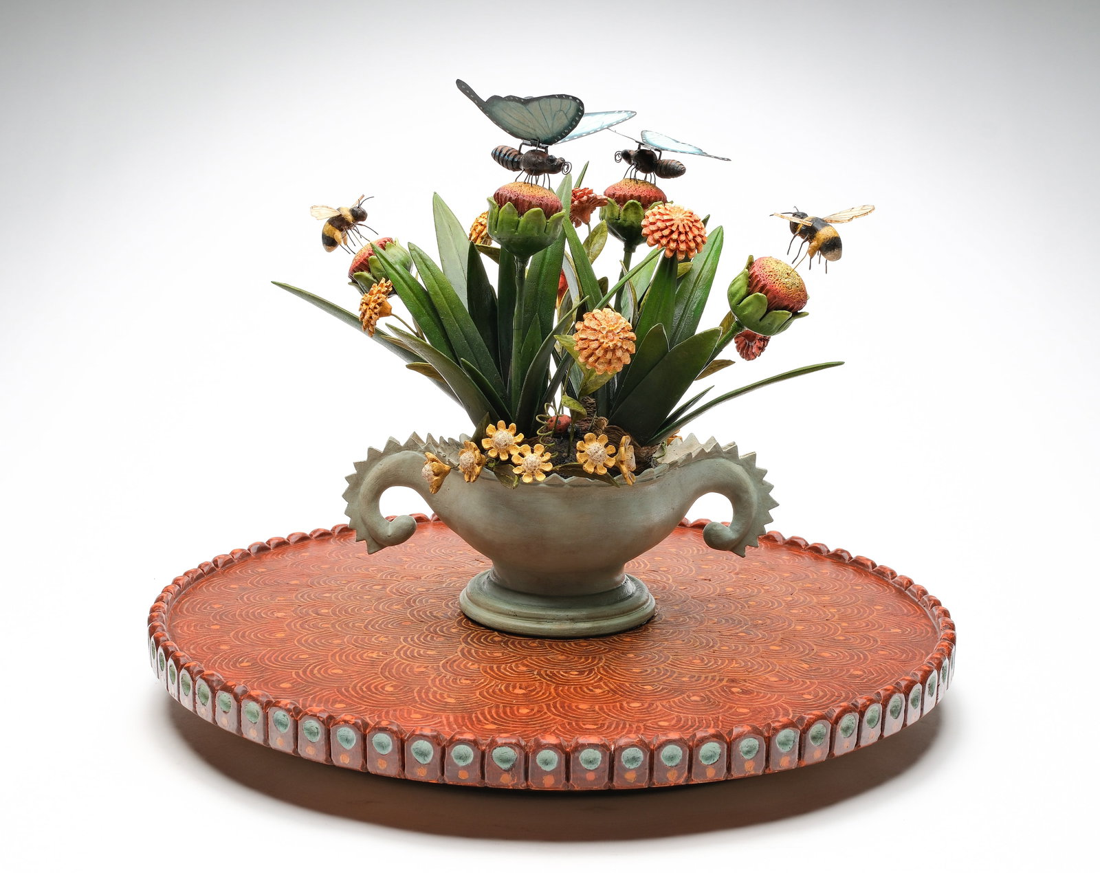 Frank Finney (b.1947), Cape Charles, Virginia.: Carved wooden vase and flower motif. On a turntable with mechanized movement when the table gently rotates. Measuring 19" tall and 24" wide. 