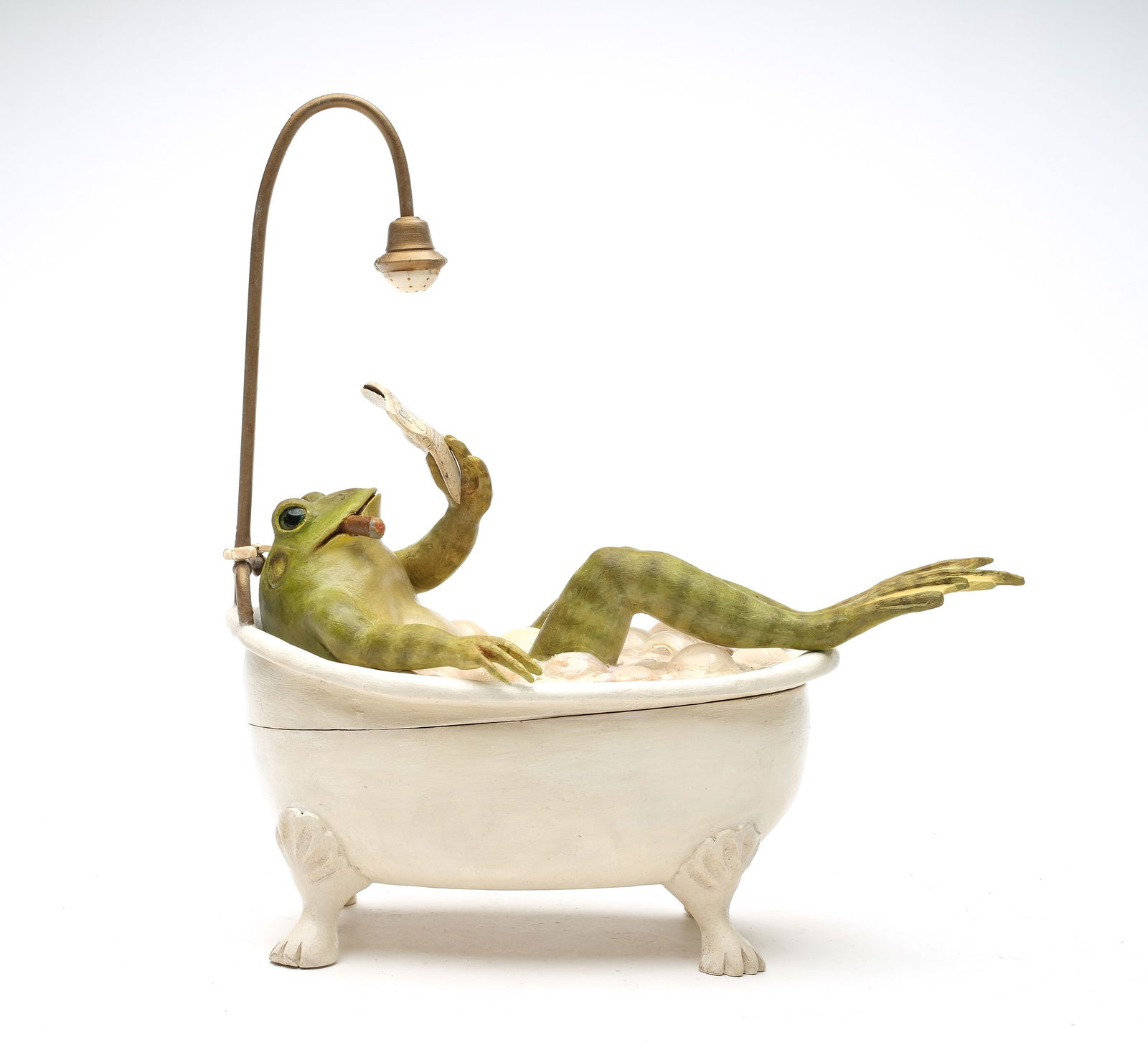 Frank Finney (b.1947), Cape Charles, Virginia.: Bull frog in a bubble bath. Reading "The Racing Forum" newspaper, with a cigar gently tucked to one side of his mouth. Frog is enjoying a bubble bath in a vintage tub that doubles as a shower. Made wi