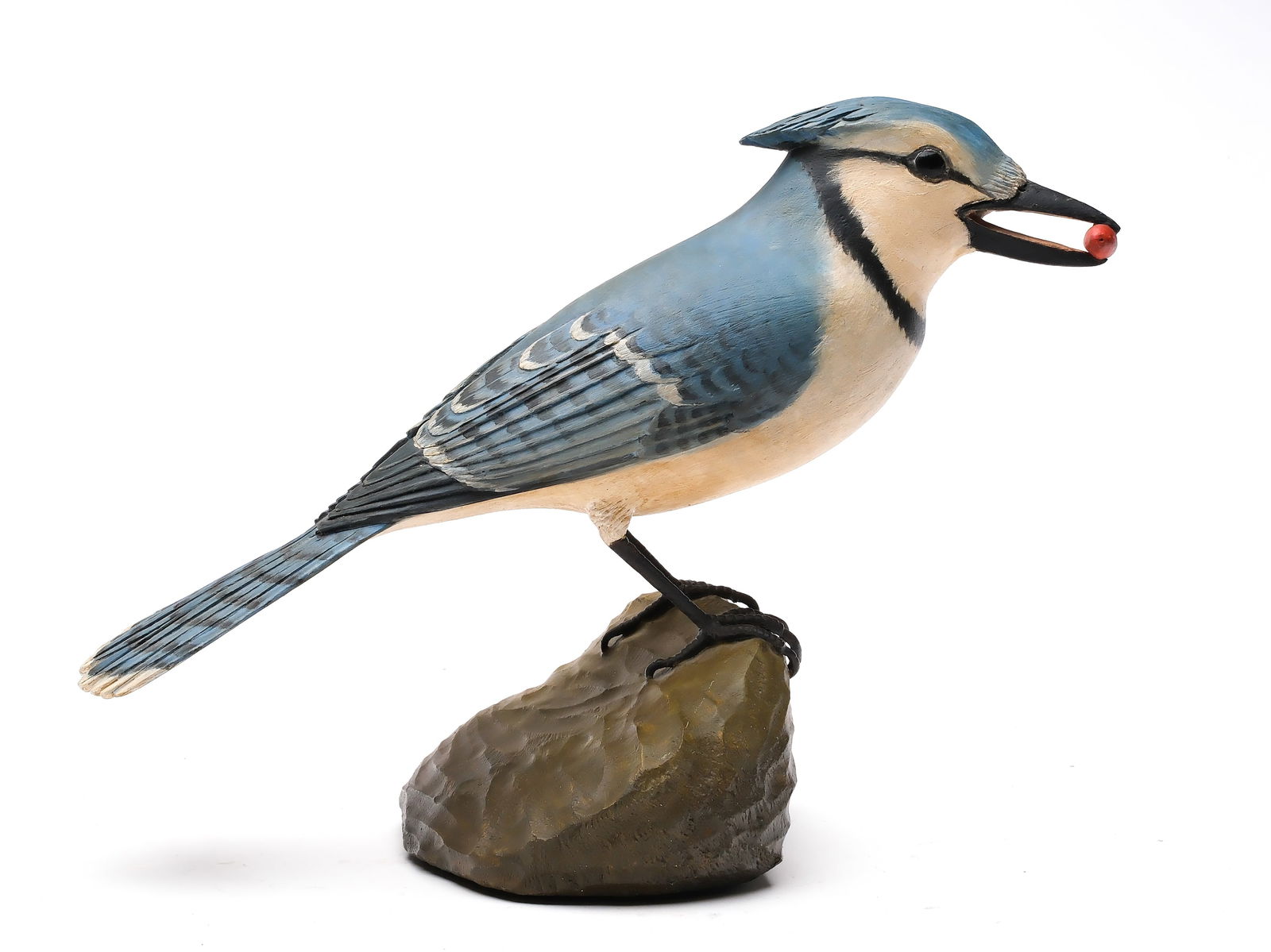 Frank Finney (b.1947), Cape Charles, Virginia.: Full size decorative bluejay. Slightly turned head with berry clutched in beak. Relief wing and tail feather carving. Maker's initials carved in base. Measures 12" long, stands 8.25" tall. Proven