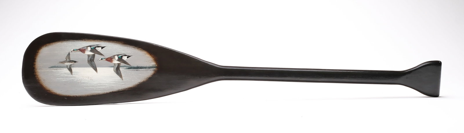 Jim Schmiedlin (1945-2015), Bradfordwoods, Pennsylvania.: Carved and patined paddle. On the blade is a scene of three widgeon. Signed and dated 2011 with the word widgeon written in the water. Measures 35.5" long.