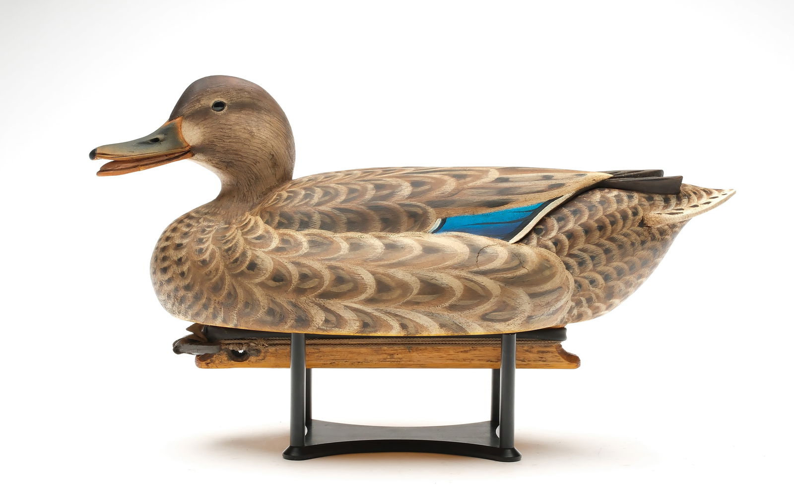Marty Hanson (b. 1965), Hayward, Wisconsin.: Calling mallard hen. Hollow carved with deep relief carved crossed wingtips. Tucked and slightly turned head with open bill. Maker's ink stamp on underside. Bird is also named "Nora". Measures 16.25"