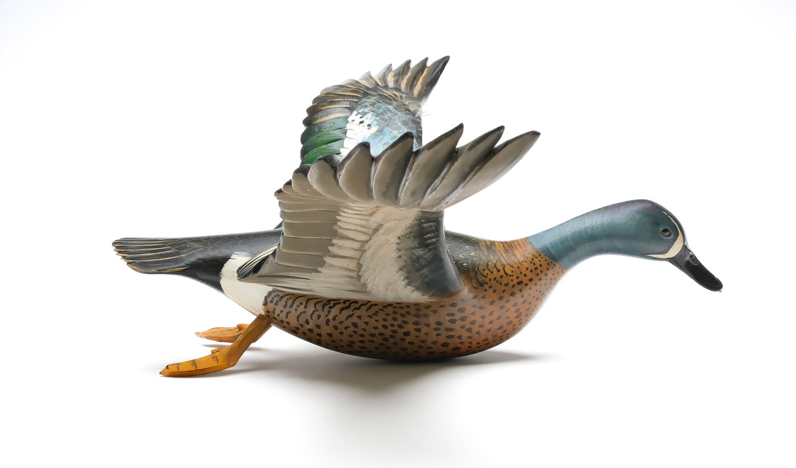 Mike Borrett, (b.1960), Madison, Wisconsin.: Flying bluewing teal. Outstretched wings with dep relief feather carving. "Borrett 12" carved in wing. Measures 16.5" with a 22.75" wingspan.