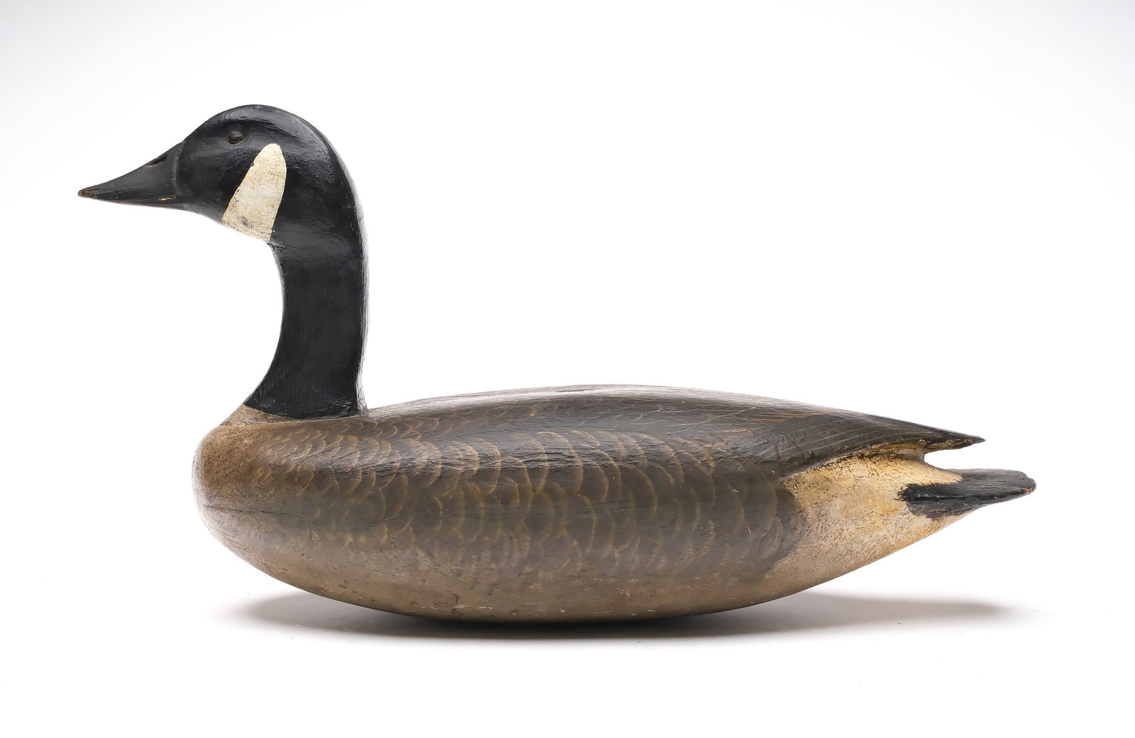 Enoch Reindahl (1904-2000), Tustin, Wisconsin.: Canada goose. Slightly upswept head pose and raised crossed wingtips. Solid body is smaller than the hollow versions. Measures 20.5" long. Provenance: Dr. Michael Shannahan collection.